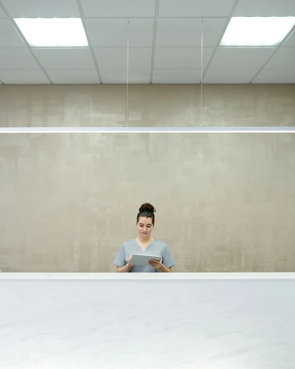 Team member reviewing the day's register on a tablet at the front desk